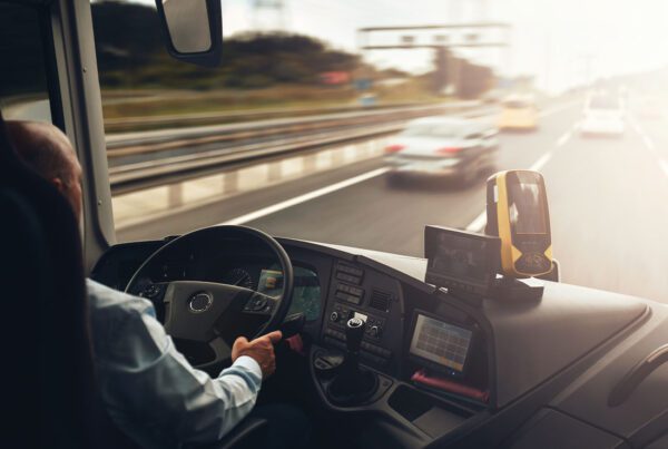 Business Auto Telematics Insurance - Interior of Cab of a Truck With Driver in Motion on a Highway