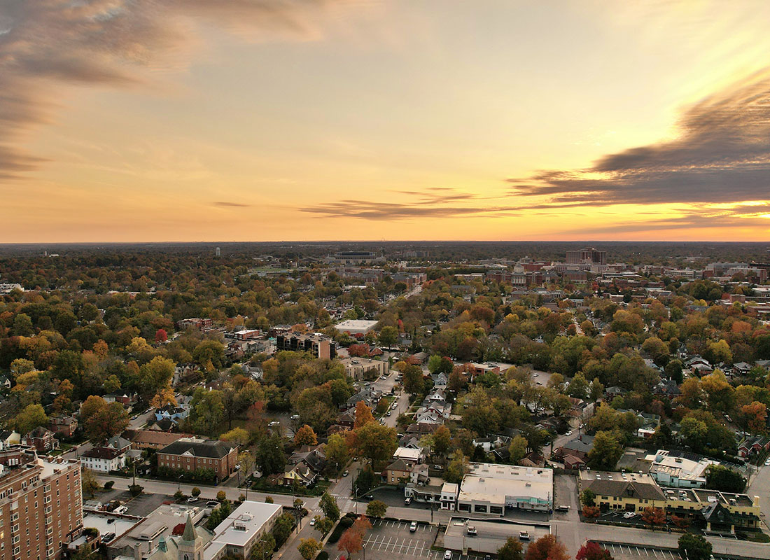 Crestview Hills, KY - Aerial View of Commercial Buildings Along Main Street and Homes Surrounded by Colorful Fall Foliage at Sunset in Crestview Hills Kentucky